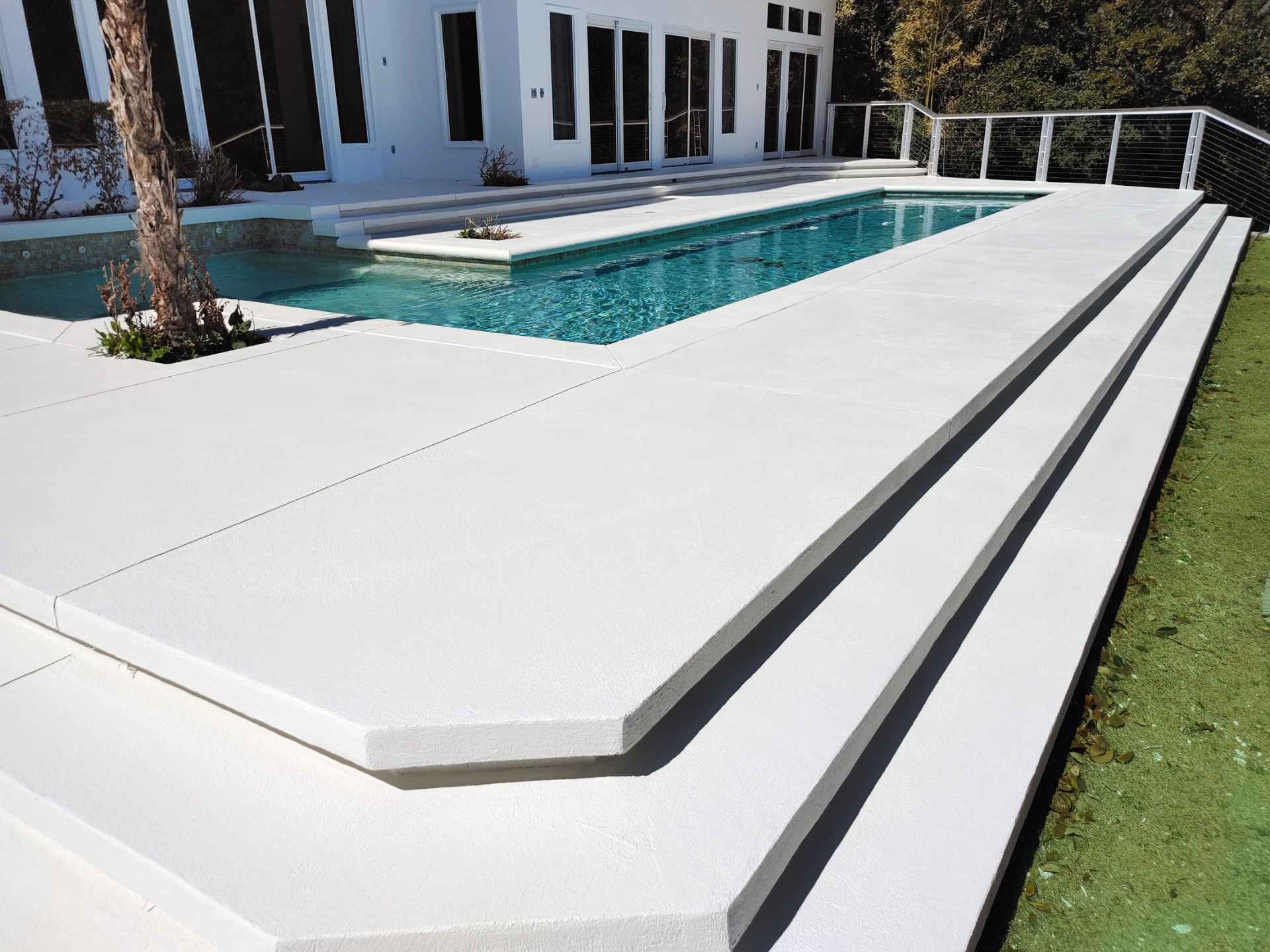 Modern white pool deck resurfacing