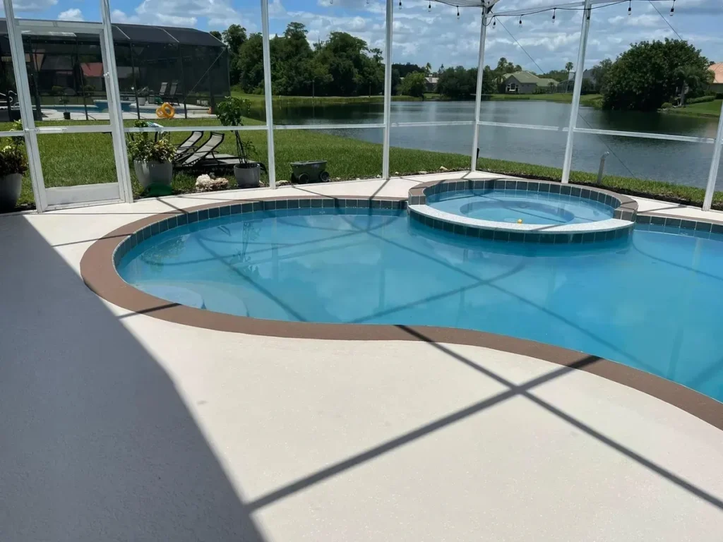 Refinished lakefront pool deck with textured cool-deck coating by Concrete Renewal LLC
