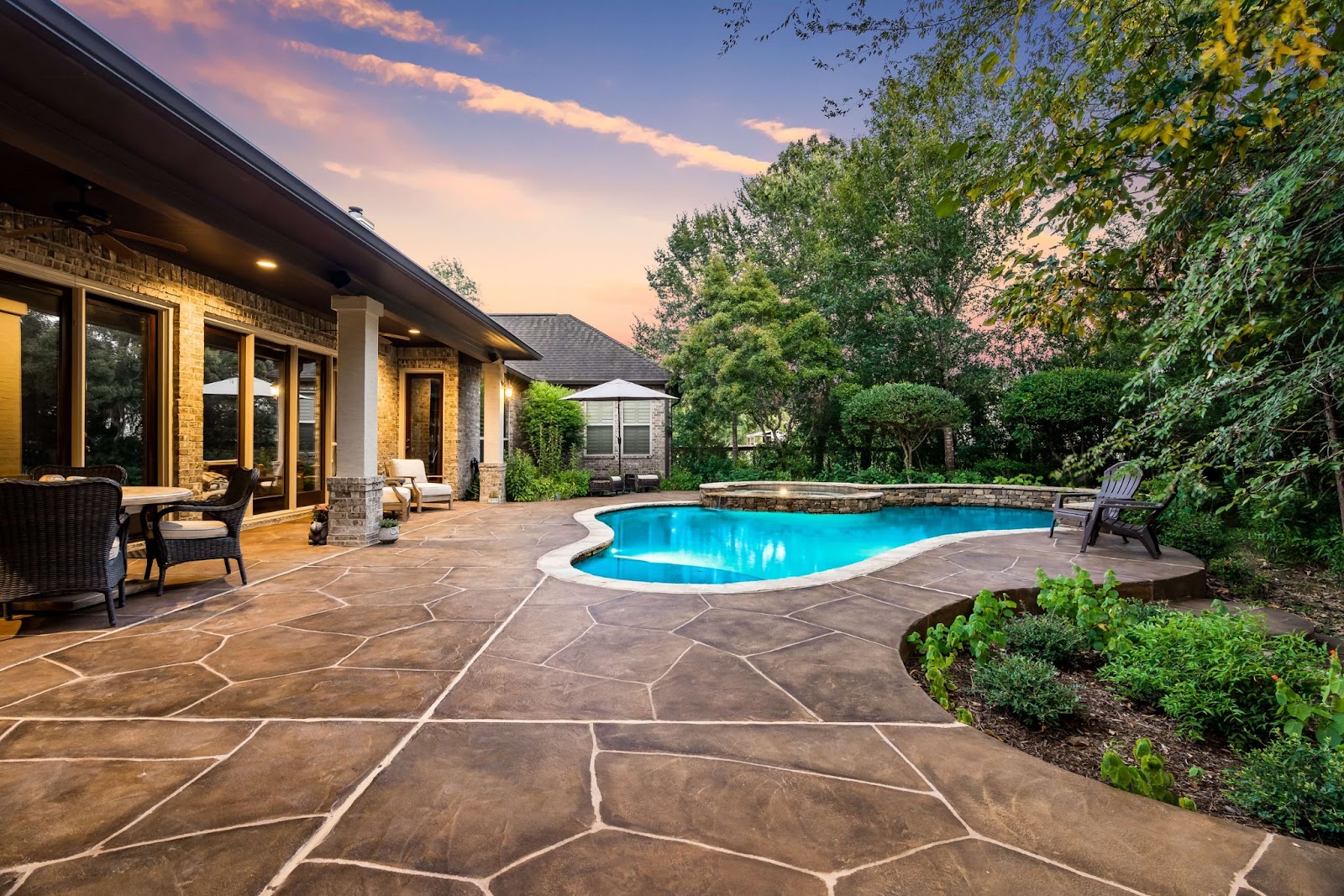 Stamped concrete pool deck patio at sunset